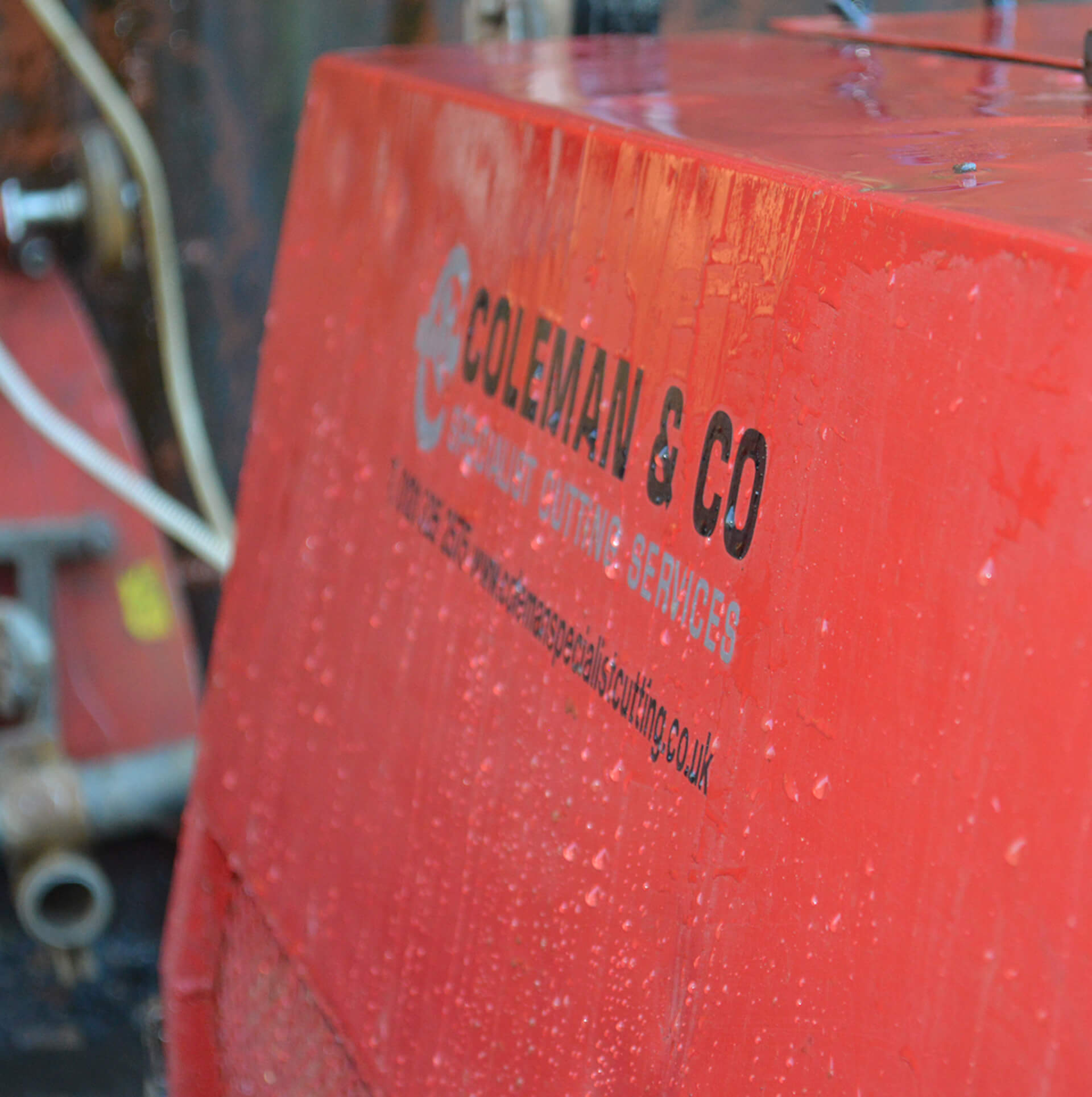 close up image of Coleman and Co branding on a red generator.