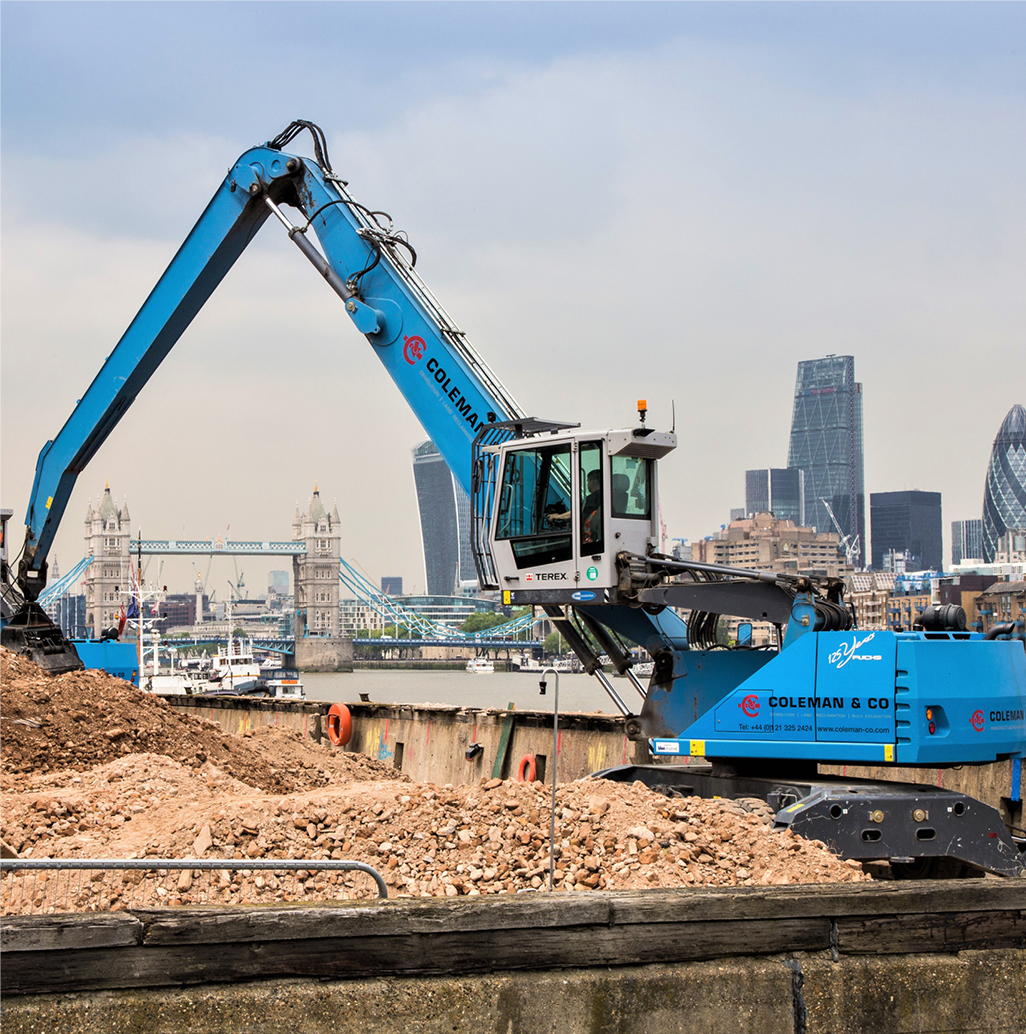 excavator sorting and stockpiling ground materials.